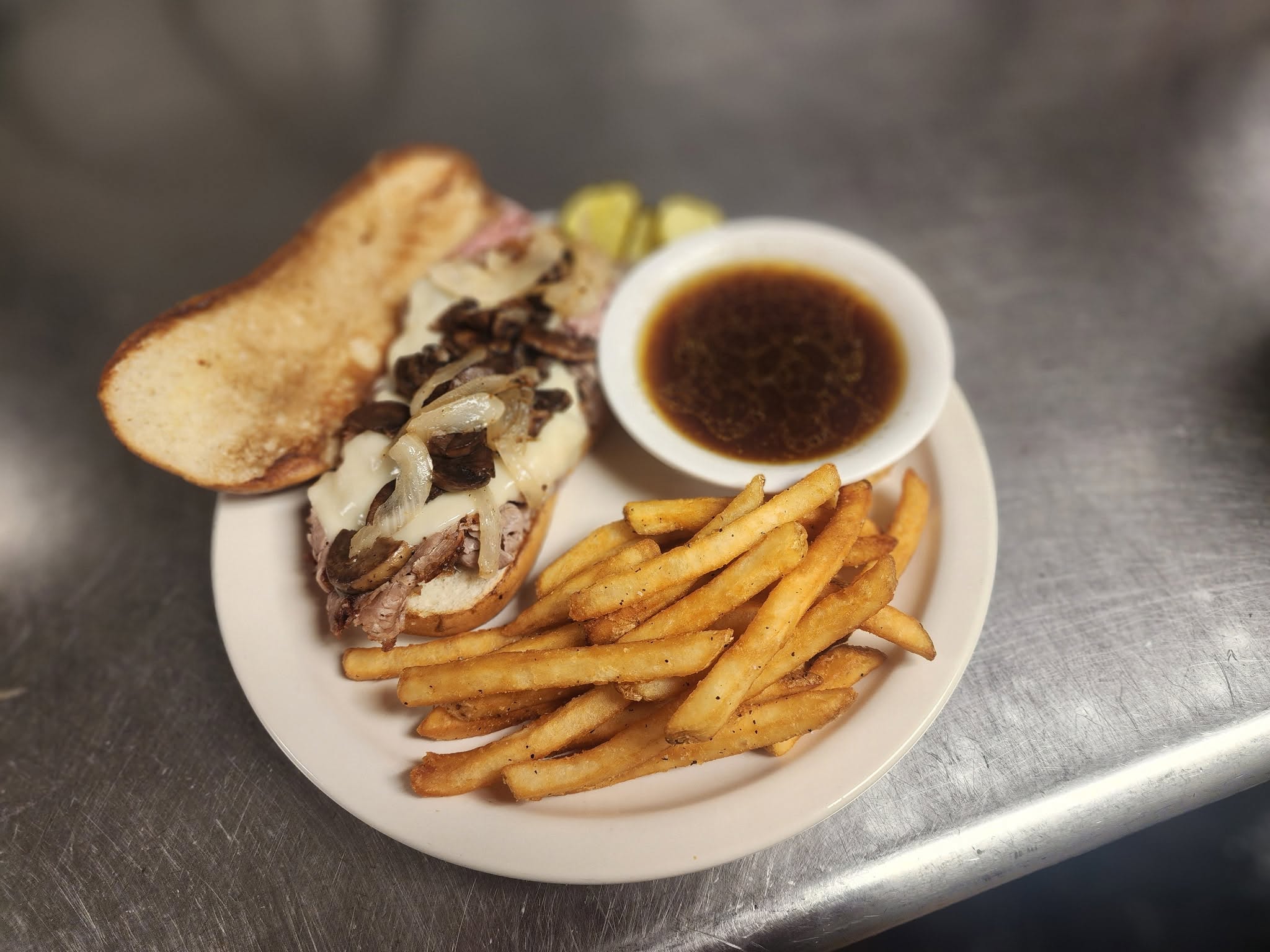 French dip sandwich with fries and au jus